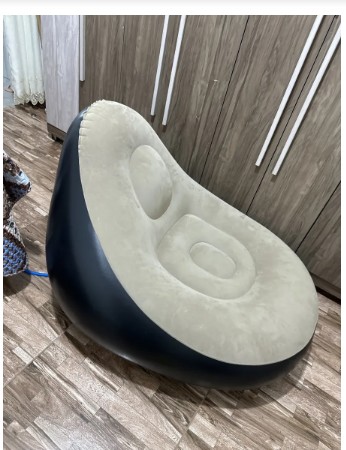 Customer photo showing the inflatable lounge chair in a bedroom